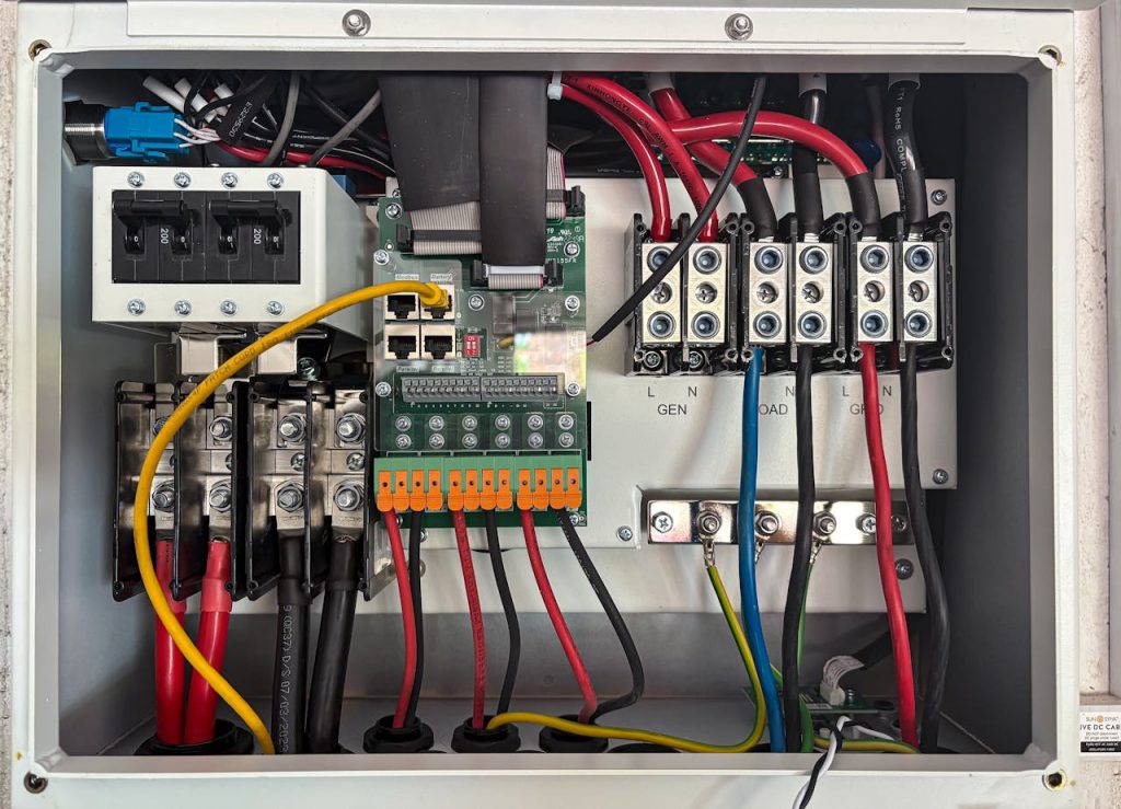 detailed-interior-of-an-electrical-control-panel-28942196 Inside view of an electrical control panel showing circuits and connections.