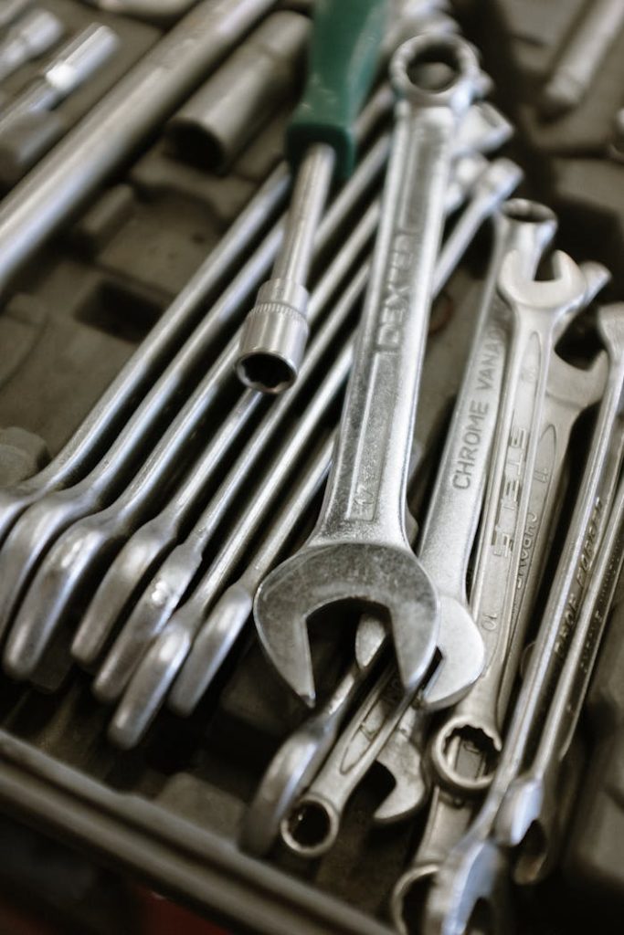 stainless-steel-combination-wrench-set-4480452 A detailed image of wrenches and tools neatly arranged in a workshop setting.